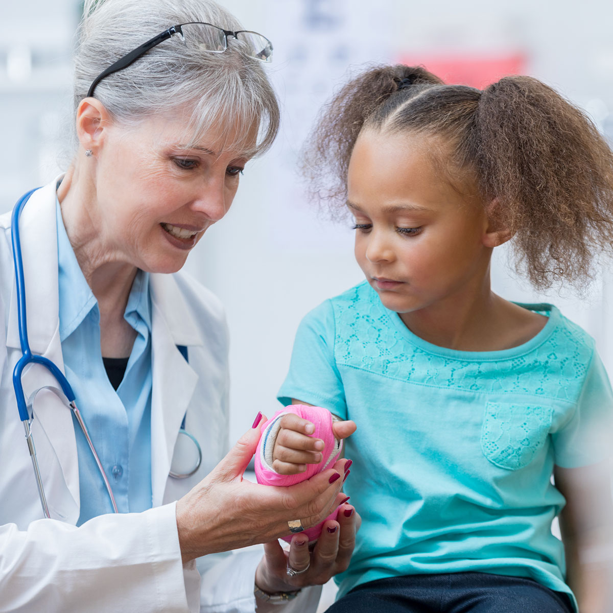 Doctor examining girls cast