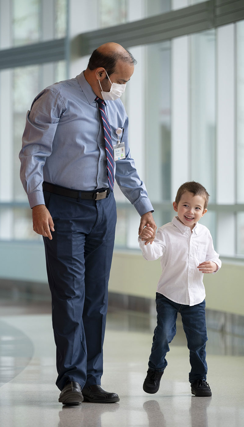 Little boy holding doctor's hand