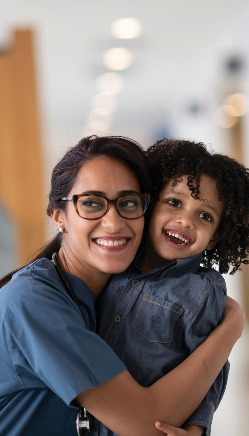 Nurse hugging child